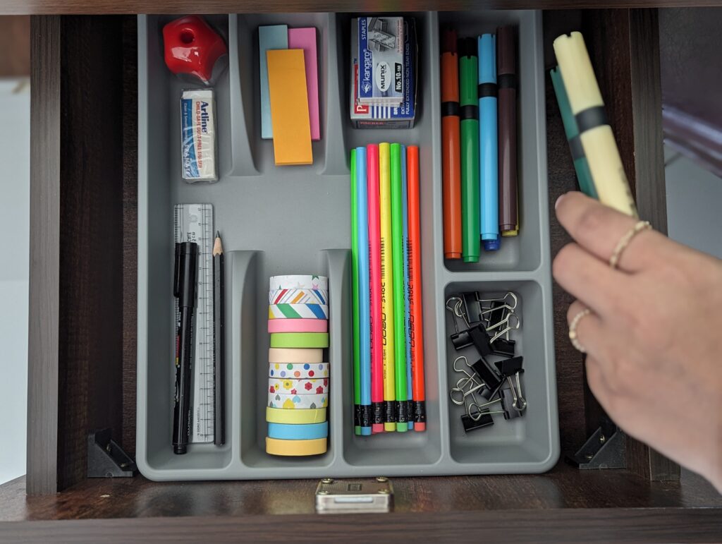 Organized drawer with pencil, tapes, sharpner, eraser, scale, postits,paper clips