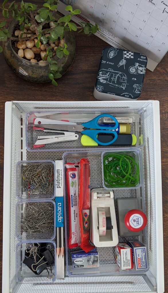 paper clips, pins, pencils, tape, rubber band, stamp, stapler, whitner, scirrors organized
